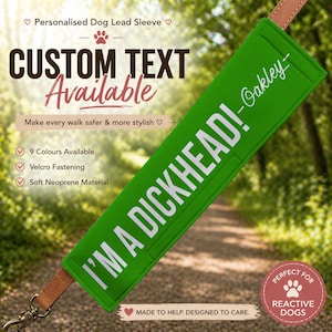 May include: A green dog lead sleeve with the text "I'M A DICKHEAD! -Oakley-" in white. The sleeve is attached to a brown leather leash. The text "CUSTOM TEXT Available" is also visible. The product is designed for reactive dogs.