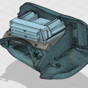 May include: A 3D rendering of a mechanical component, featuring a light blue rectangular structure with multiple layers, mounted on a beige base. The component is encased in a dark teal, textured housing with visible bolts and a curved arm.