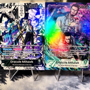 May include: Two trading cards featuring Dracule Mihawk from "The Seven Warlords of the Sea." One card has a black and white background with a character holding a sword. The other card has a colorful background with a character holding a glass of wine. Each card has a 5000 power rating.