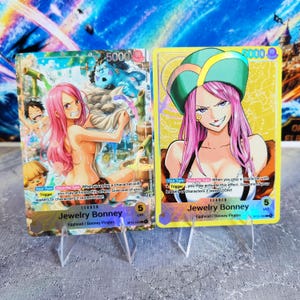 May include: Two One Piece trading cards featuring Jewelry Bonney. The left card shows Bonney in a hot spring with other characters. The right card features a close-up of Bonney wearing a green hat. Both cards display the text Jewelry Bonney.