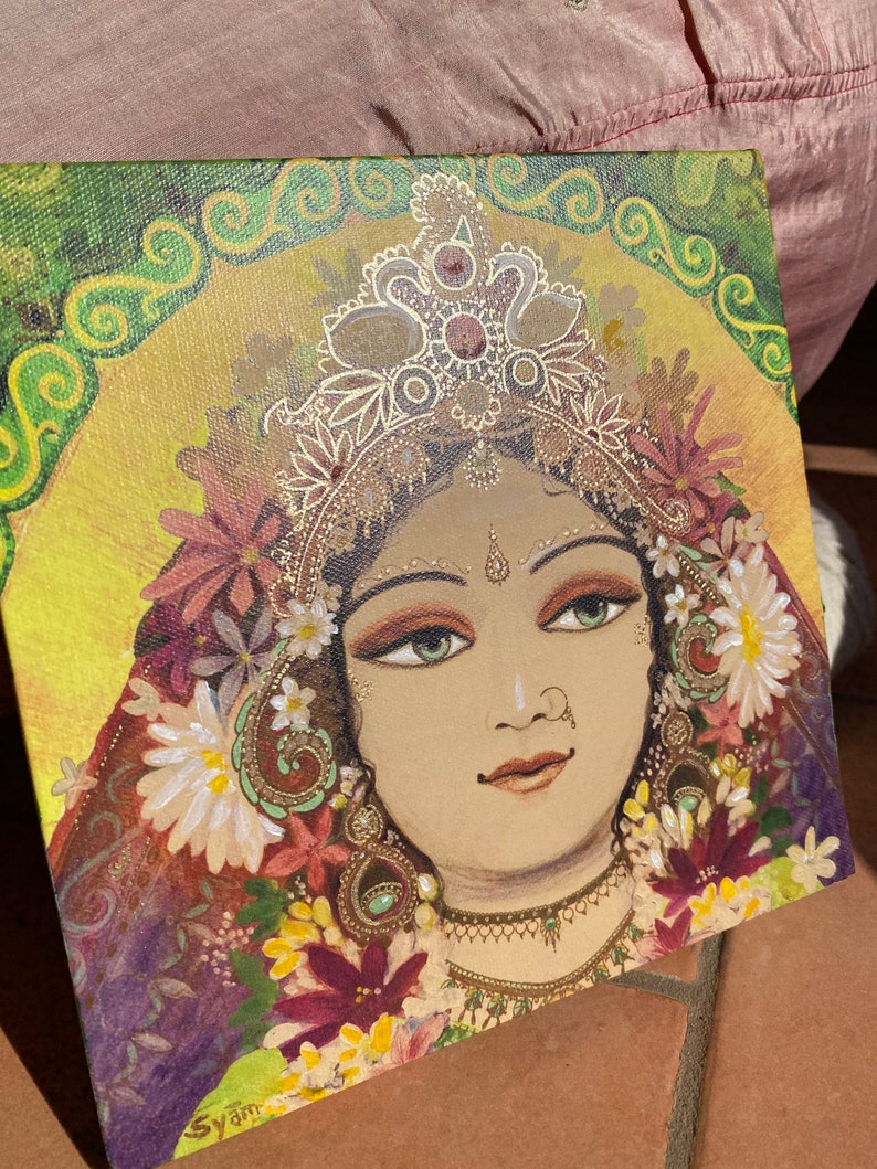 May include: A painting of a woman with a golden crown and floral decorations. The woman has dark hair, green eyes, and a gentle expression. The background is a vibrant green and yellow with swirling patterns.