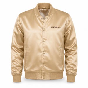 May include: A shiny gold satin bomber jacket featuring a ribbed collar, cuffs, and hem. The jacket has a front snap-button closure, two side pockets, and the text CUSTOM LOGO printed in dark brown on the upper left chest area of the garment.