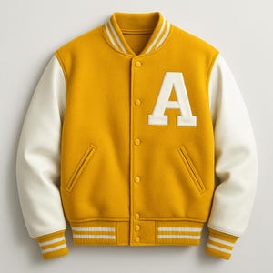 May include: Mustard yellow varsity jacket with cream-colored sleeves and a white letter "A" patch. The jacket features a ribbed collar, cuffs, and hem with white stripes, and two front pockets. The jacket has a button-up closure.