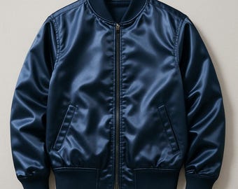 May include: A navy blue satin bomber jacket with a full-length zipper closure. The jacket features a ribbed collar, cuffs, and hem. Two front pockets are visible. The jacket is a solid color and has a shiny appearance.
