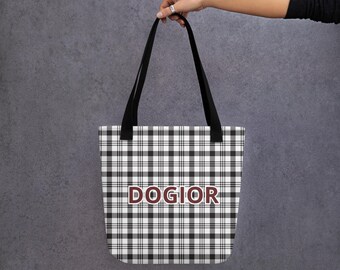 May include: A black and white plaid tote bag with black handles. The word "DOGIOR" is printed in maroon across the center of the bag. The bag is held up by a person.