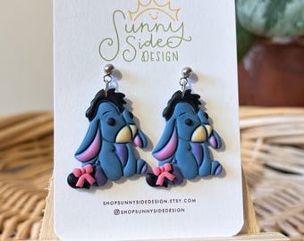 Pendientes de arcilla polimérica de Eeyore / Pendientes colgantes hechos a mano inspirados en Disney / Eeyore con cola de lazo rosa / Joyería del Bosque de los Cien Acres / Lindo regalo