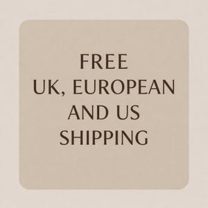 May include: A square graphic with rounded corners featuring a light beige background and dark brown text that reads: FREE UK, EUROPEAN AND US SHIPPING. The design is centered and uses a simple, clean serif font for clear readability on the light surface.