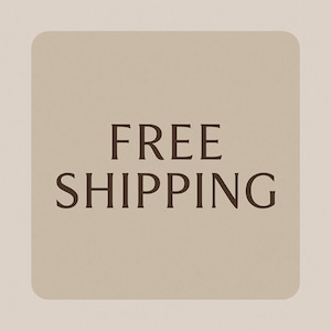 May include: A square, beige graphic with rounded corners displays the words "FREE SHIPPING" in a dark brown, serif font. The text is centered on the graphic, which is set against a lighter beige background.