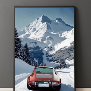 May include: A framed print featuring a red sports car driving on a snowy road towards a snow-covered mountain range. The car is a classic model, with a sleek design. The sky is clear and blue, and the overall scene evokes a sense of adventure.
