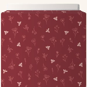May include: A stack of burgundy file folders with a repeating pattern of white bees and floral illustrations. The folders have a white tab at the top for labeling. The design is a whimsical and nature-inspired.