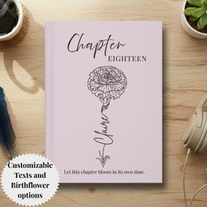May include: A light purple hardcover journal featuring a black line art illustration of a carnation flower. The text reads Chapter EIGHTEEN, the name Claire, and the phrase Let this chapter bloom in its own time in a clean, black serif font.