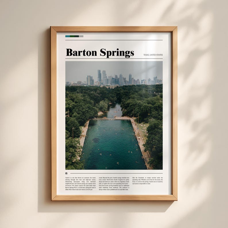 May include: A framed print featuring Barton Springs in Austin, Texas. The image shows a large, rectangular pool surrounded by trees, with a city skyline in the background. The text "Barton Springs" is at the top.