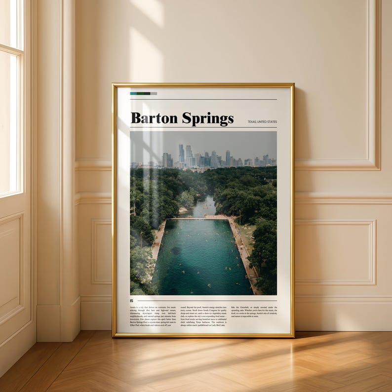 May include: A framed print featuring a photograph of Barton Springs in Austin, Texas. The image shows a rectangular pool of clear blue water surrounded by lush green trees, with a city skyline in the background. The words "Barton Springs" are printed at the top.