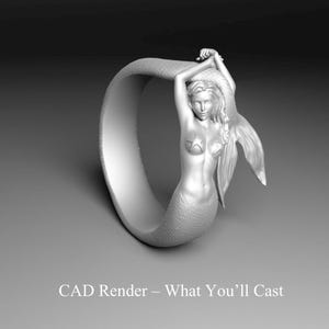 May include: A silver ring featuring a mermaid design. The mermaid has long flowing hair, star-shaped details on her chest, and a scaled tail. The ring's band curves around the mermaid, and the text "CAD Render - What You'll Cast" is at the bottom.