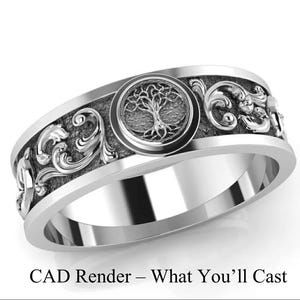 May include: A silver ring with a detailed design. The ring features a central circular emblem with a tree motif, surrounded by ornate scrollwork and other decorative elements. The text "CAD Render - What You'll Cast" is at the bottom.