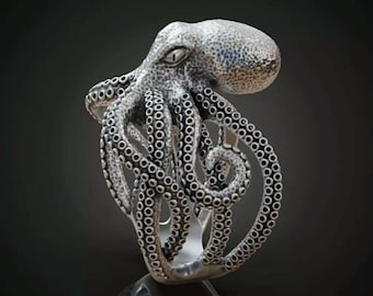 May include: A detailed silver octopus ring with tentacles wrapping around the band. The octopus's head is textured, and the eyes are visible. The ring is displayed on a reflective surface. Text at the bottom reads "CAD Render - What You'll Cast."