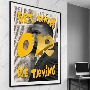 May include: A framed black and white poster with the text "GET RICH OR DIE TRYING" in yellow. The poster features a man in a suit, with the words overlaying his image. The background is a wall with a marble pattern.