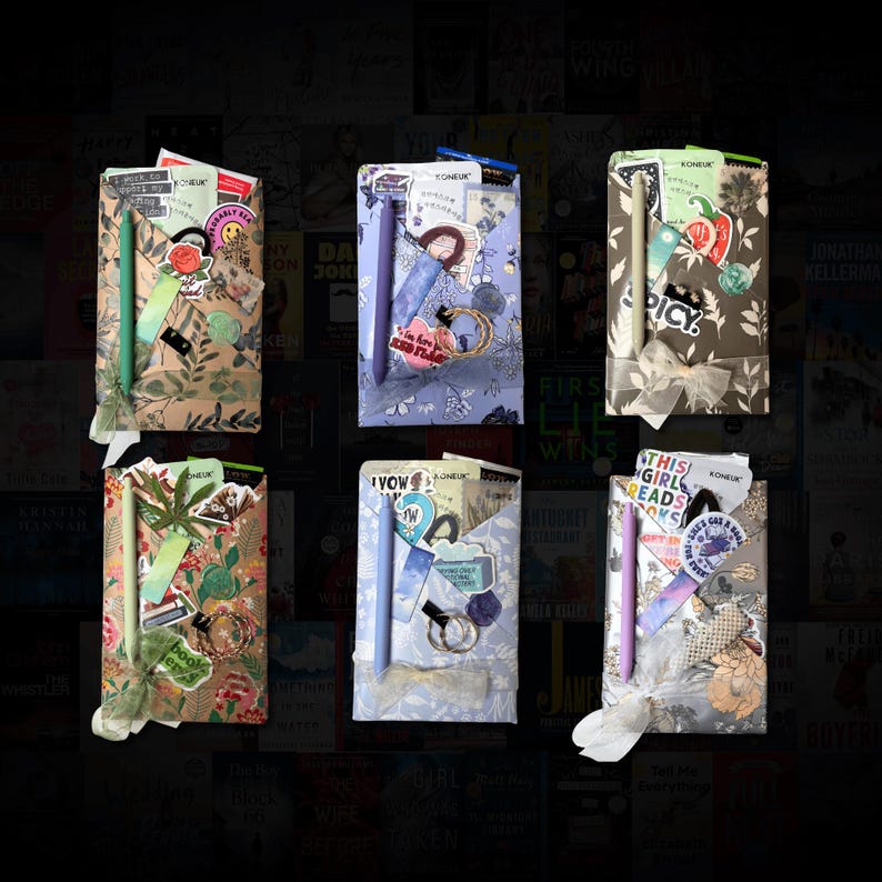 May include: Six gift sets, each wrapped in patterned paper and tied with ribbon. Each set includes a pen, stickers, and other small items. The sets have different colour schemes and patterns, with some featuring floral and botanical designs.