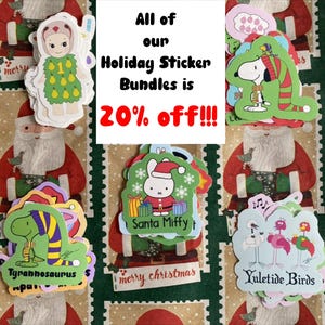 May include: A collection of colorful holiday-themed stickers, including images of Santa Claus, Snoopy, a dinosaur, and a bunny wearing a Santa hat. The stickers are on a background with a Santa Claus design and the text "merry christmas". The text "All of our Holiday Sticker Bundles is 20% off!!!" is also visible.