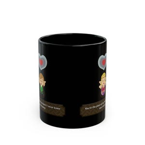 Puede incluir: Taza de cerámica negra con personajes de dibujos animados y bocadillos en forma de corazón. La taza tiene el texto "You're the piece of my heart I never knew was missing."