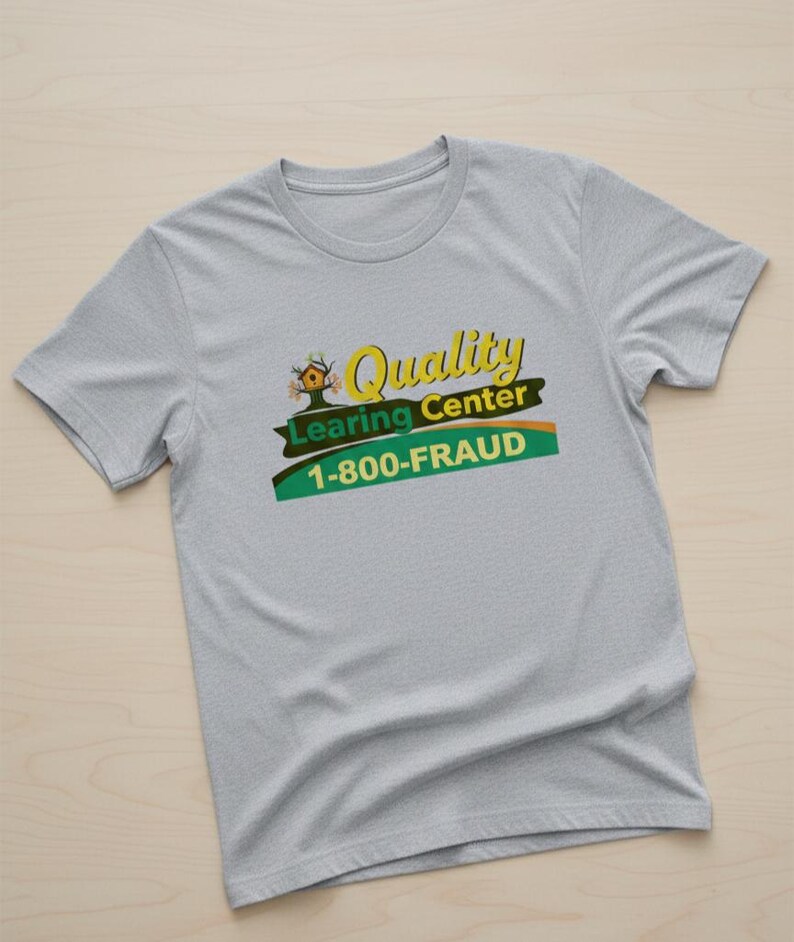 May include: A light gray t-shirt with the words "Quality Learning Center" in yellow and green, and the phone number "1-800-FRAUD". The shirt has short sleeves and a crew neck.