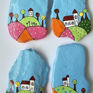 Set of 4 village inspired hand painted rocks
