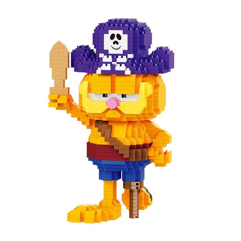 May include: A block figure of a cartoon cat in a pirate costume. The figure is primarily yellow and orange, with a purple pirate hat featuring a white skull and crossbones. It holds a wooden sword and wears blue shorts.