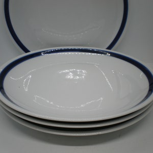 May include: Three white oval bowls with a single blue band around the rim.