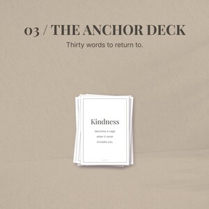 May include: A stack of white cards with the text "Kindness" and a quote. The cards are part of "THE ANCHOR DECK" with the tagline "Thirty words to return to." The background is a neutral beige color.
