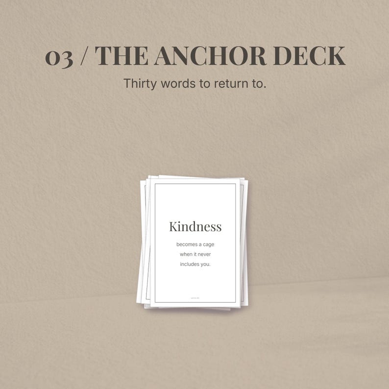 May include: A stack of white cards with the text "Kindness" and a quote. The cards are part of "THE ANCHOR DECK" with the tagline "Thirty words to return to." The background is a neutral beige color.