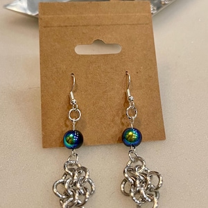 chainmaille earrings with a blue and black bead