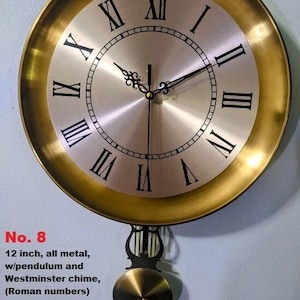 May include: A 12-inch, all-metal wall clock with a gold-colored frame and a silver-colored face. The clock features black Roman numerals, a pendulum, and a Westminster chime.