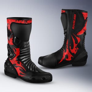 Puede incluir: Un par de botas de moto negras y rojas con el nombre de la marca RIVALION impreso en rojo en el lateral. Las botas tienen un diseño de caña alta con paneles protectores reforzados, punteras texturizadas y zonas acanaladas flexibles.