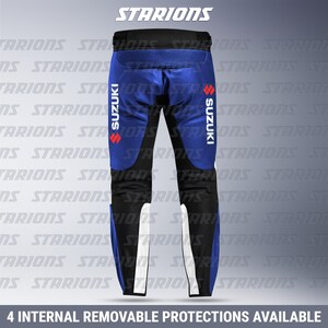 May include: Blue and black motorcycle pants with white accents and the Suzuki logo. The pants have a ribbed design on the upper back and the text "4 INTERNAL REMOVABLE PROTECTIONS AVAILABLE".