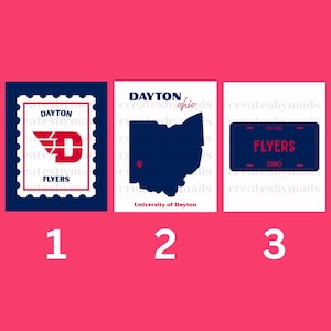 May include: Three rectangular prints featuring University of Dayton themes. The first is a postage stamp design with a red D logo. The second shows a dark blue map of Ohio with a location pin. The third is a dark blue license plate graphic.