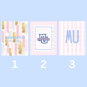 May include: Three rectangular prints featuring Marquette University branding. The first has pink, gold, and white brushstrokes with the text MARQUETTE. The second shows the MU logo in a scalloped frame. The third displays MU in blue on pink stripes.