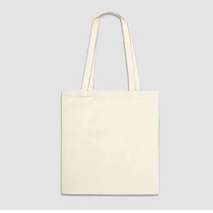 May include: Cream-coloured tote bag with two matching handles. The bag is rectangular and appears to be made of canvas or a similar fabric. The handles are attached at the top corners.