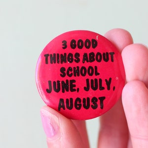 May include: Red button with black text that reads "3 good things about school June, July, August".