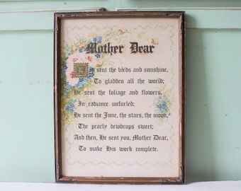 May include: A framed poem titled "Mother Dear" with a floral design and the text: "He sent the birds and sunshine, To gladden all the world; He sent the foliage and flowers, In radiance unfurled; He sent the June, the stars, the moon, The pearly dewdrops sweet; And then, He sent you, Mother Dear, To make His work complete."