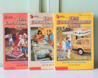 May include: Three paperback books from The Baby-Sitters Club series. The books are titled "Dawn and the Big Sleepover", "Stacey's Emergency", and "Good-bye Stacey, Good-bye". The books are all by Ann M. Martin.