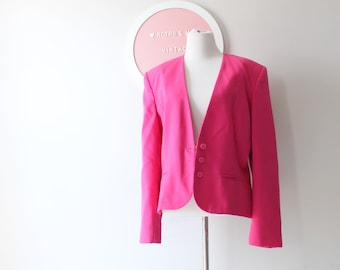May include: A bright pink blazer with a single button closure and a deep V-neck.