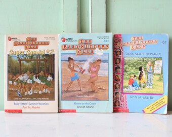 May include: Three paperback books from the Baby-sitters Club series. The first book is Super Special #2, the second is Down on the Coast, and the third is Dawn Saves the Planet. All three books feature illustrations of girls on the covers.