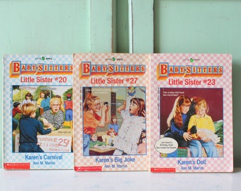 May include: Three paperback books from the Baby-Sitters Little Sister series. The books are titled "Karen's Carnival #20", "Karen's Big Joke #27", and "Karen's Doll #23". Each book features a colorful illustration of children on the cover.