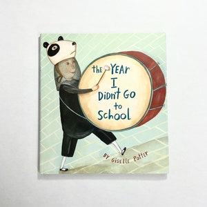 May include: A book cover with a green background and a person wearing a panda mask holding a drum. The text on the cover reads "The Year I Didn't Go to School" by Giselle Potter.