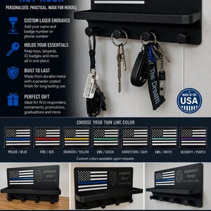 May include: A black metal wall-mounted key hook rack with a top shelf and four hooks. The rack features a laser-engraved American flag with a blue stripe, a police badge emblem, and the text "DENNIS 5051 Come home safe." It measures 10" W x 5.25" H x 3" D.
