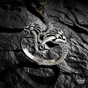 Dramatic lighting on gothic angel wing ring showcasing feather texture and silver reflections. Adjustable 925 sterling silver band with celestial wing motif, photographed against dark slate background. Ideal for witchy aesthetic, dark romantic style, fallen angel theme jewelry.
