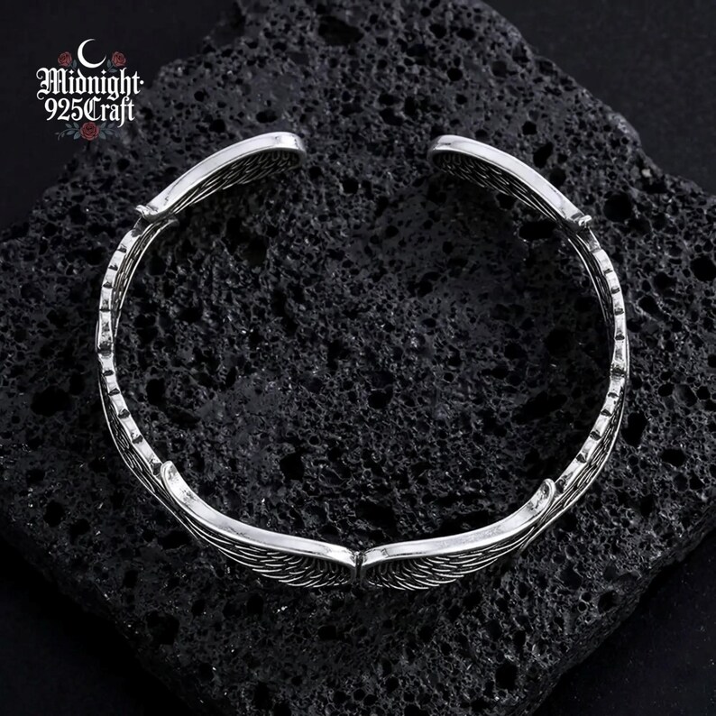 Packaging view of the Angel Wings 925 sterling silver bracelet presented in a jewelry pouch, gift-ready for special occasions. The bracelet rests inside, showcasing how it arrives as a birthday gift, Valentine's Day present, Christmas jewelry, or Mother's Day gift.