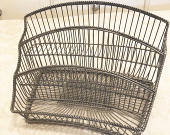 May include: A silver wire dish rack with three tiers. The rack is designed to hold plates and bowls.