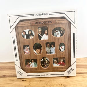 May include: A wooden multi-photo frame with various sized openings, displaying family photos. The frame is made of solid oak and has the word "MEMORIES" above the photo openings. The packaging reads "Made in U.S.A.!"