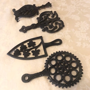 Mix Match Trivet Footed Metal Pot Holder Dinner Serving Table Protection From Heat Also A Decorative Trivet Holding a Unique Set Of Four